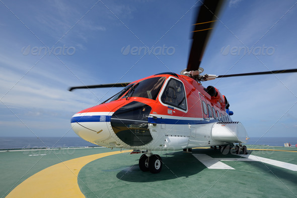 Helicopter landing on oil rig to pick up worker