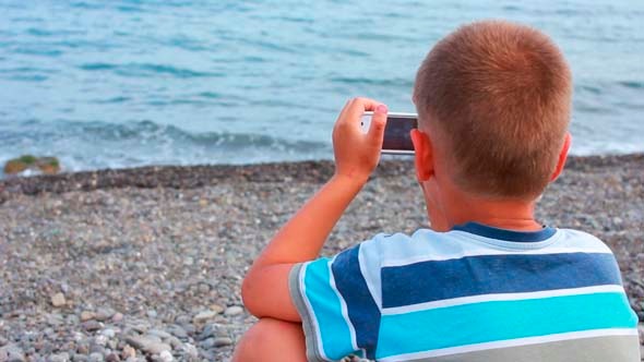 Boy on Beach with Phone 6 Boy on Beach with Phone 6