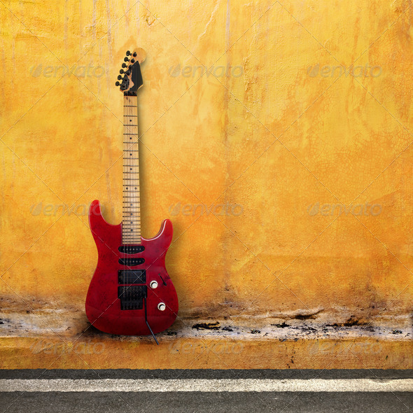 Red Old Guitar on a Grudge Yellow Wall