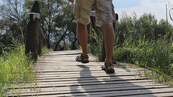 Man Steps Across a Footbridge Man Steps Across a Footbridge
