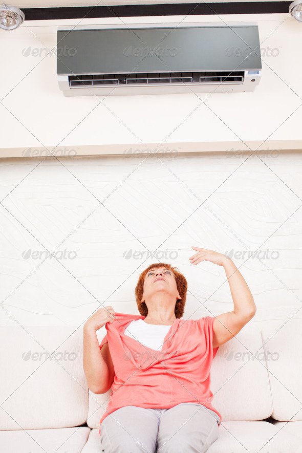 Woman escapes from the heat under the air