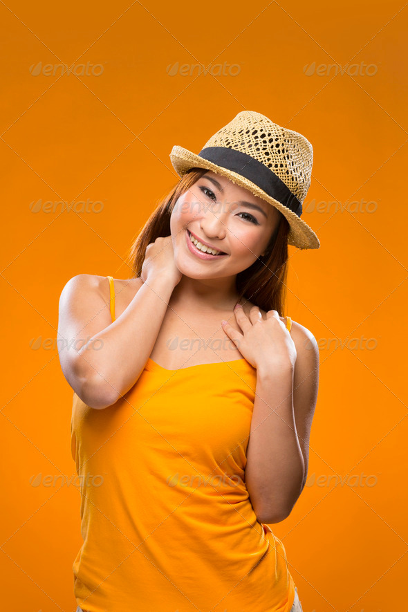 Fashionable Asian Woman wearing straw hat.