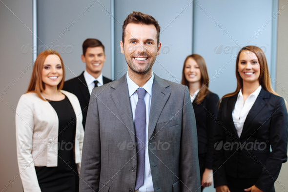 Group of business people with team leader in foreground