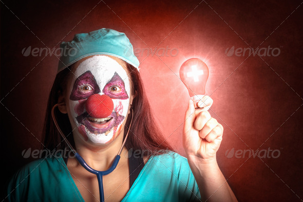 Clown doctor holding red emergency lightbulb