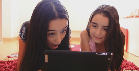 Two Happy Teenage Girls Using Tablet Computer 1 Two Happy Teenage Girls Using Tablet Computer 1