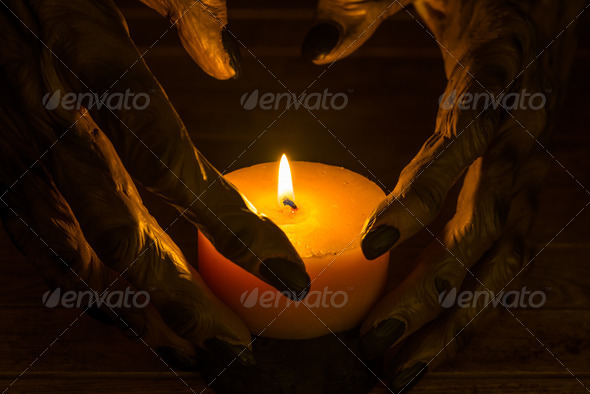 Werewolf hands and a burning candle