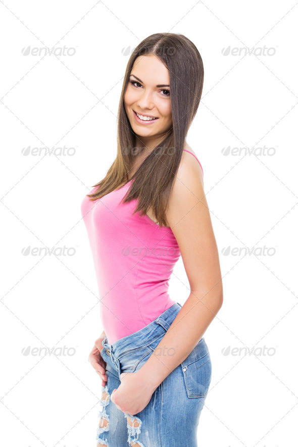 Attractive teenage girl wearing pink shirt and jeans - Stock Photo - Images