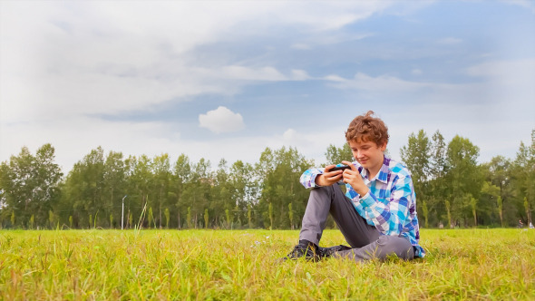 Young Man Communicates on the Smartphone Young Man Communicates on the Smartphone