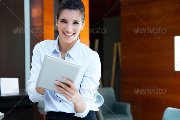 beautiful modern businesswoman holding tablet computer