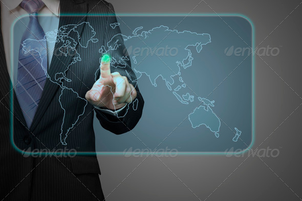 Businessman pushing on future touch screen icon with world wide map in space