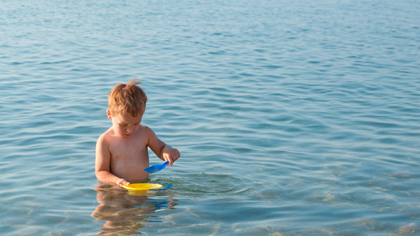 Little Boy Playing in the Shallow Sea Little Boy Playing in the Shallow Sea