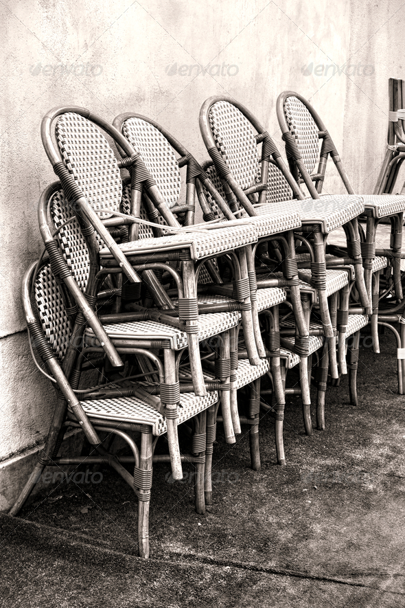 Classic Cafe Wicker Chairs Stacked against a Wall