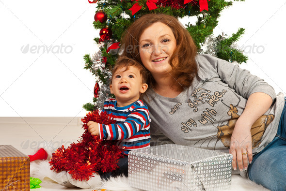 Happy mother and son under Xmas tree