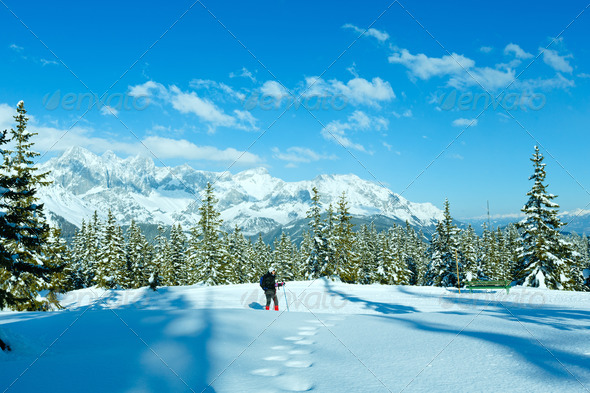 Winter mountain landscape and woman on walk