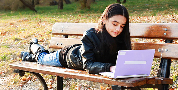 Teenager Sitting On Bench With Laptop 2 Teenager Sitting On Bench With Laptop 2