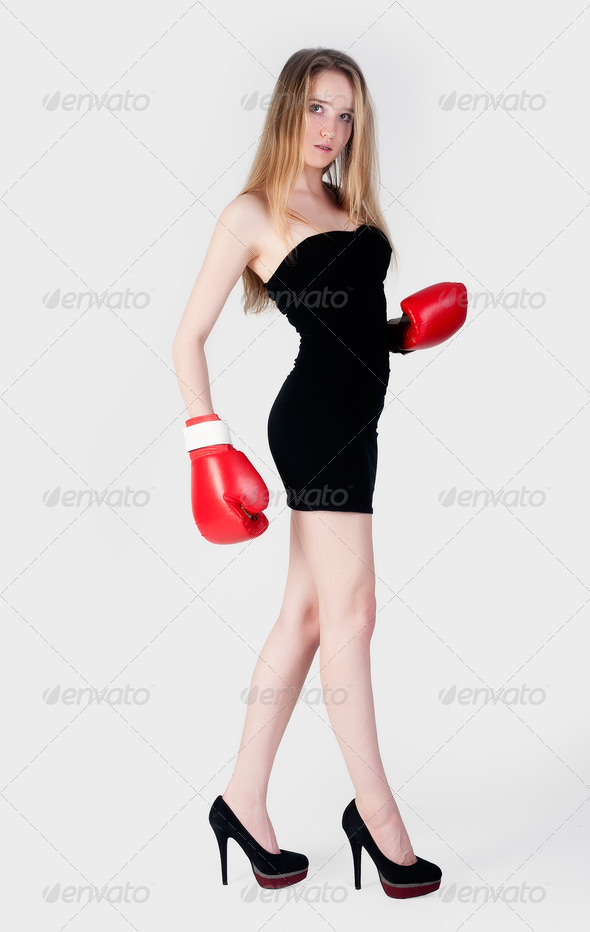 Fashion blonde woman with boxing gloves on white background