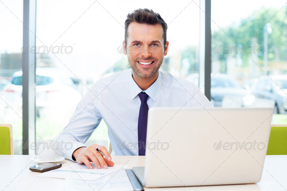Happy businessman working at the office