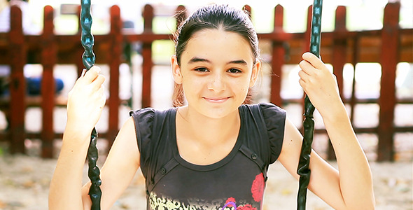 Teenage Girl on Swing Smiling at Camera Teenage Girl on Swing Smiling at Camera