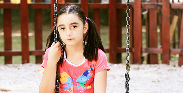 Sad Young Girl Sits on Swing Sad Young Girl Sits on Swing