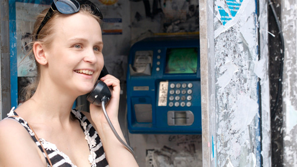Attractive Woman Using A Public Telephone Attractive Woman Using A Public Telephone