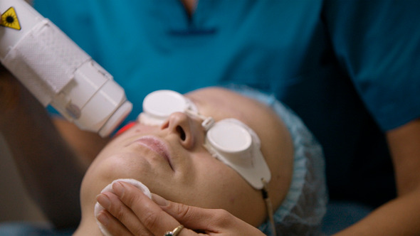 Doctor Doing A Fractional Skin Laser Treatment Doctor Doing A Fractional Skin Laser Treatment
