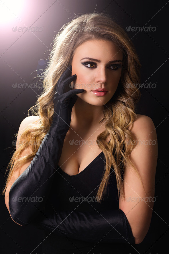 Glamorous young blonde woman in black - Stock Photo - Images