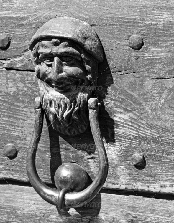 bronze door knockers with a face to knock