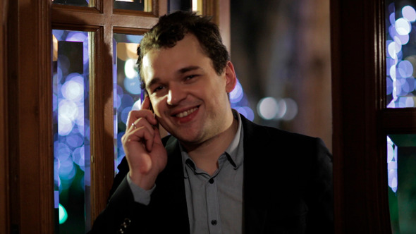 Man Smiling Happily As He Chats on His Mobile Man Smiling Happily As He Chats on His Mobile