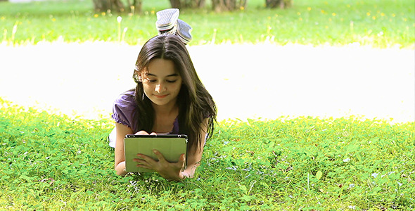 Teenage Girl Using Digital Tablet on Grass 2 Teenage Girl Using Digital Tablet on Grass 2
