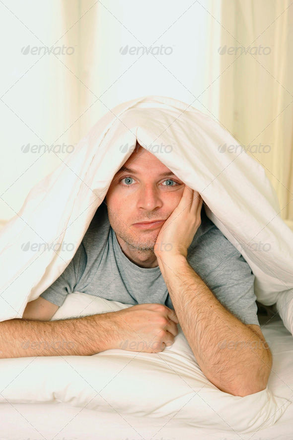 man in bed with eyes opened suffering insomnia and sleep disorder