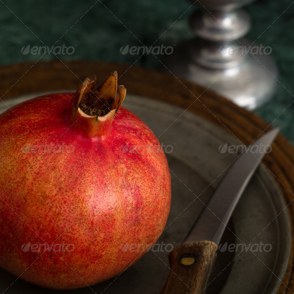 Red Pomegranate On A Pewter Plate