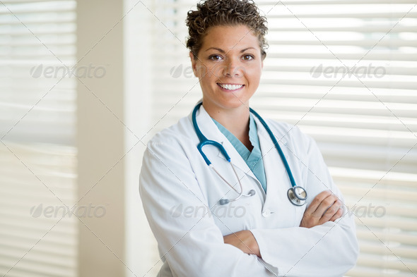 Confident Cancer Specialist Standing Arms Crossed In Clinic