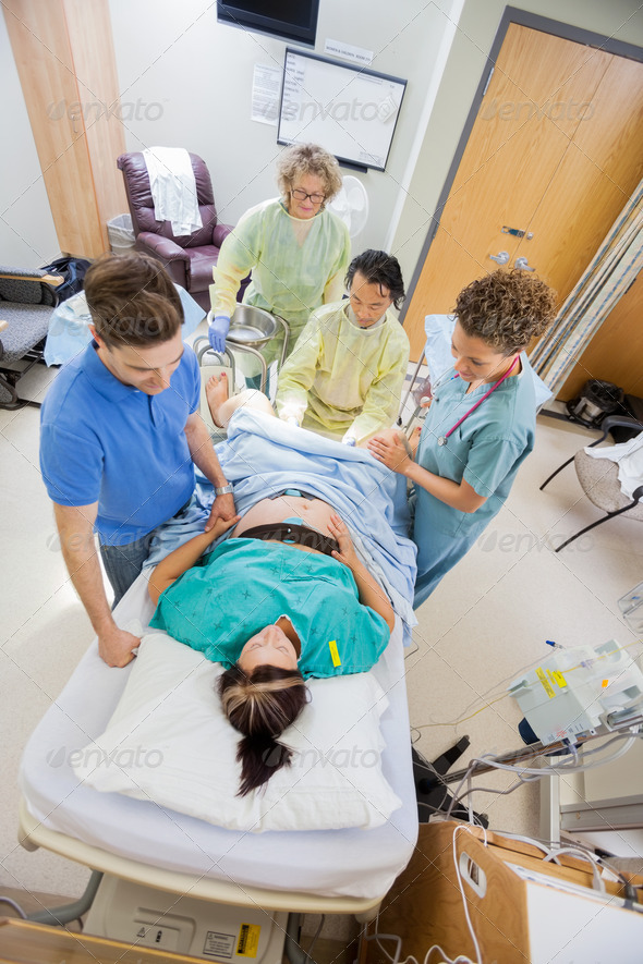 Doctors With Nurse Operating Pregnant Woman During Delivery (Misc) Photo Download