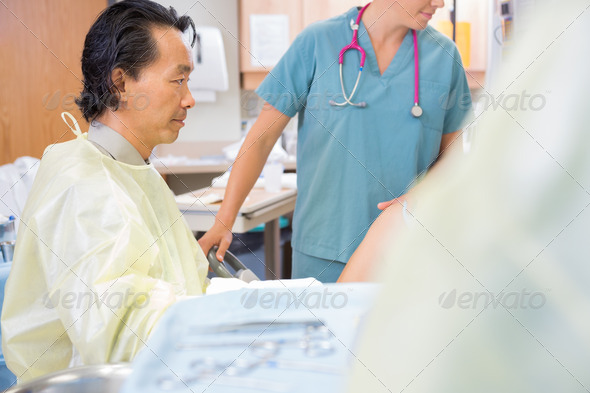 Male Doctor Delivering Baby in Hospital (Misc) Photo Download