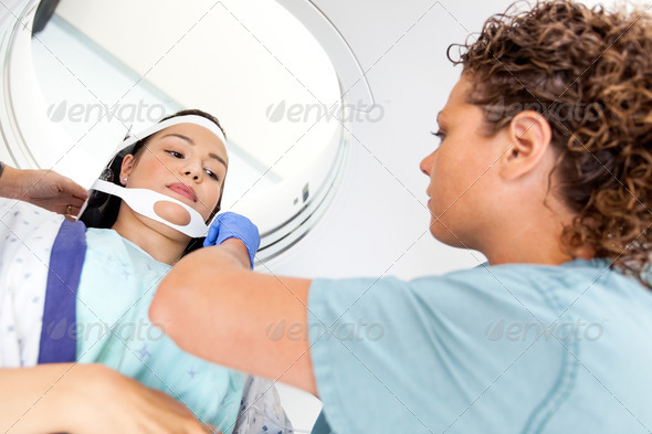 Patient Looking At Nurse Adjusting Strap Before CT Scan (Misc) Photo Download