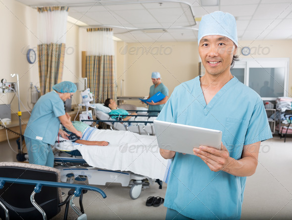 Nurse With Digital Tablet Standing In Post Surgery