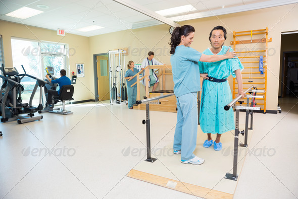 Therapists Assisting Patients In Hospital Gym (Misc) Photo Download