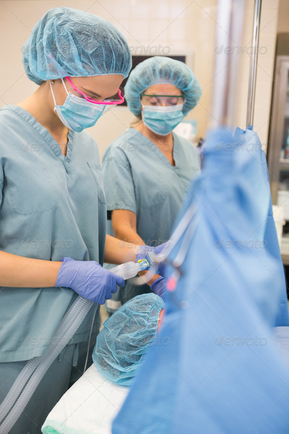 Nurse Adjusting Oxygen Mask On Patient (Misc) Photo Download