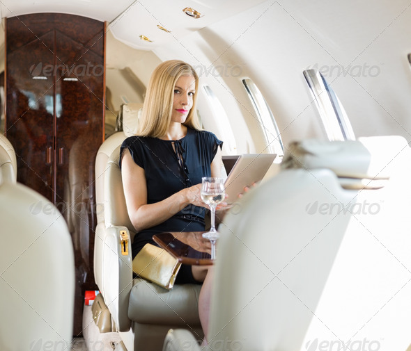 Rich Woman Using Tablet Computer In Private Jet (Misc) Photo Download