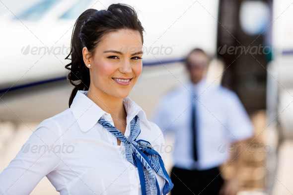 Stewardesses Smiling With Pilot And Private Jet In Background