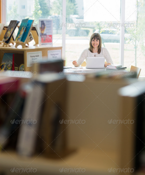Student With Laptop Studying In Library