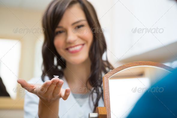 Female Optometrist Showing Contact Lens