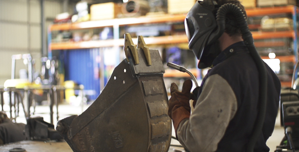 Man Wearing Safety Gear Preparing to Weld Man Wearing Safety Gear Preparing to Weld