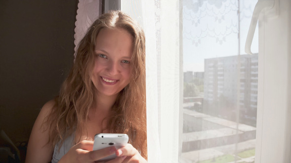 Young Woman Sends SMS Messages Young Woman Sends SMS Messages