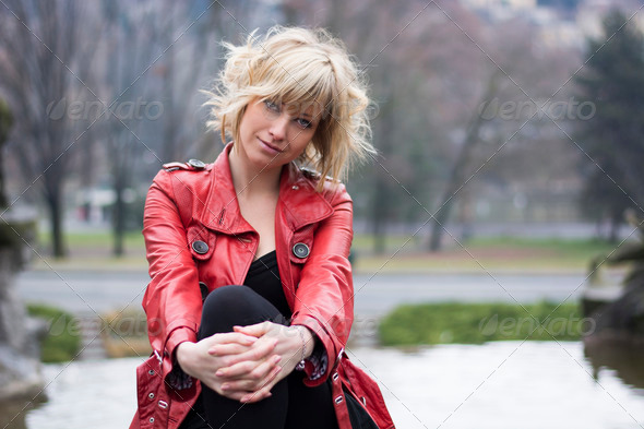 Attractive young woman with red leather jacket