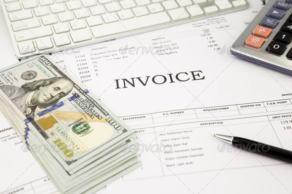 invoice documents and dollar money banknotes on office table
