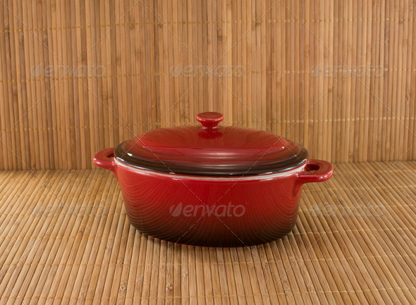 red saucepan on bamboo