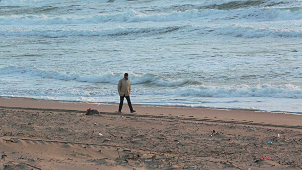 Man Walking on the Beach with Storm Waves 02 Man Walking on the Beach with Storm Waves 02