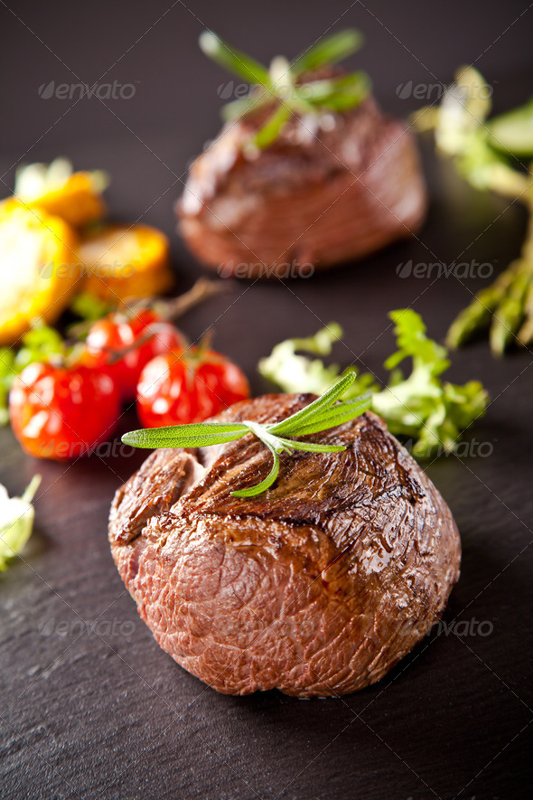 Fresh beef steaks on black stone