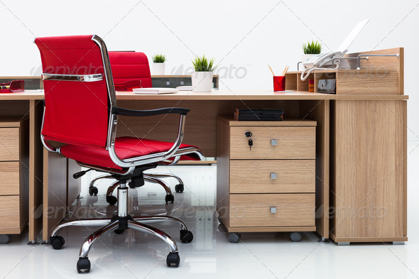 desks and red armchairs